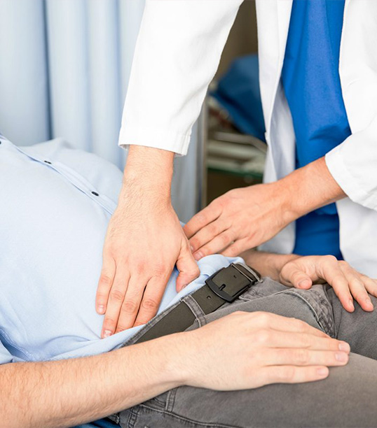 Gastroenterologist feeling the Stomach of a MedValet patient with his hands in Medellin, Colombia