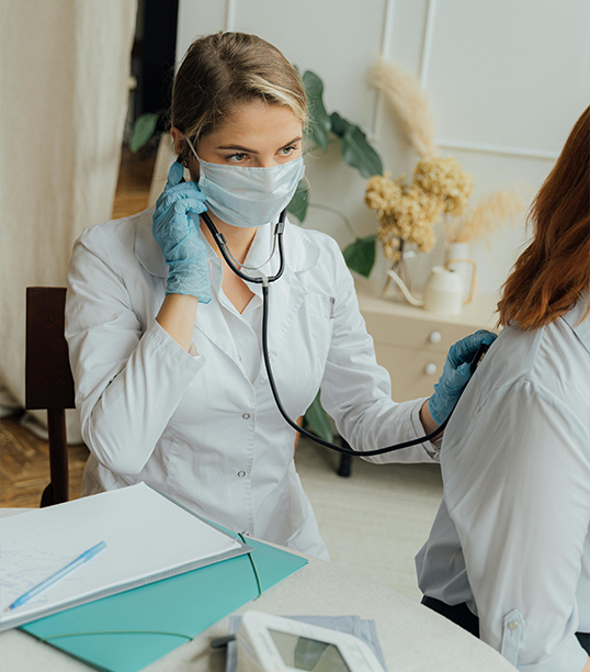 A General Practicioner performing a routine check-up on a patient.