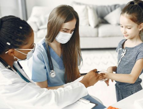 A young girl receiving a consultation with a pediatrist in Medellin.