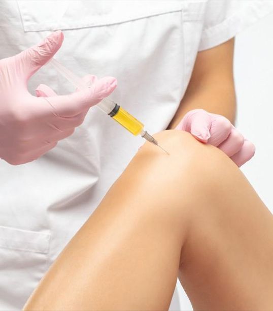 Nurse injecting Stemcells into a patient's knee to fight arthritis at a Medellín regenerative medicine facility