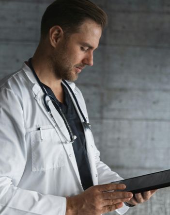 Cardiologist looking at a patient's data on his clipboard.