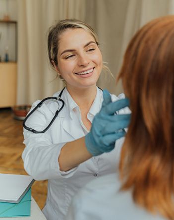 Colombian Dentist checking a MedValet patient's teeth in a Medellín dental clinic.
