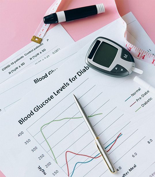 Endocrinologist reviewing glucose charts with obese patient during diabetes management appointment in Medellín