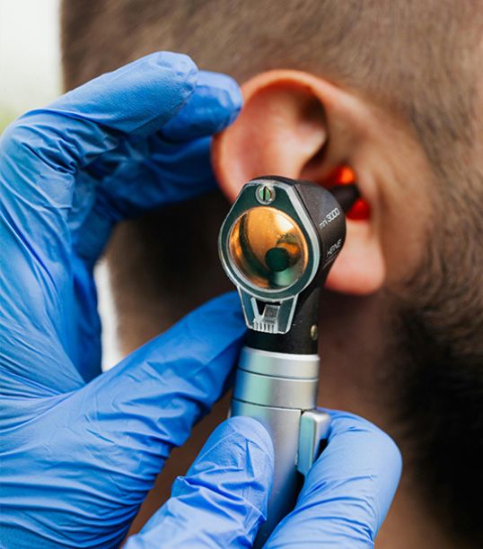 Otolaryngologist performing an ear examination in a Medellín exam room